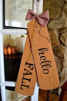 two wooden signs with the words welcome fall on them