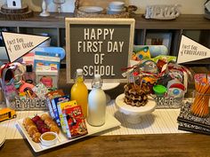 there is a sign that says happy first day of school next to some snacks and condiments