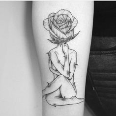 a black and white photo of a woman with a rose tattoo on her arm,