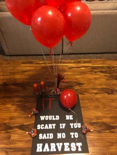 some red balloons are on top of a sign that says i would be scary if you said no to harvest