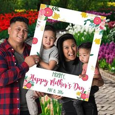 a family holding up a happy mother's day sign