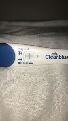 a toothbrush with the words clearblue on it is laying on a bed