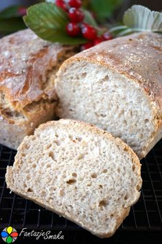 two loaves of bread on a cooling rack with holly and berries in the background