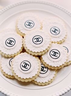 cookies decorated with chanel logos on a plate