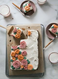 the cake is decorated with flowers and icing