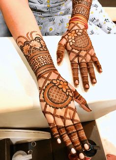 a woman's hand with henna tattoos on it