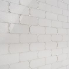 a white brick wall with circles on it