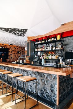 an empty bar with stools in front of it