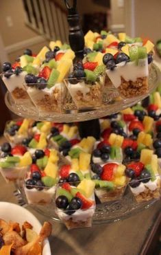 three tiered trays filled with different types of food on top of a table