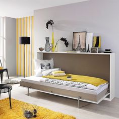 a bedroom with yellow and white decor on the walls, carpeted flooring and furniture