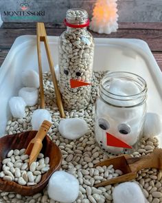 a bowl filled with beans and marshmallows on top of a table next to a jar