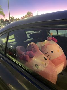 a hello kitty balloon sitting in the passenger seat of a car