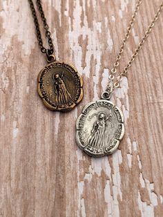 This necklace features a beautiful medal of St. Maria Goretti with elegant scroll details. The medal was hand cast in the United States from an antique piece and is available in either antiqued solid bronze or sterling silver. It measures approximately 7/8 inch. The antiqued brass or sterling silver chain closes in a lobster clasp. NOTE: In most cases, you will not receive the exact piece that is pictured. Many of the components of my pieces are made of either natural gemstone, wood or bronze. T Bronze Medallion Jewelry For Commemoration, Antique Silver Medallion With Miraculous Medal, Bronze Engraved Medallion Necklace As Gift, Memorial Bronze Engraved Necklaces, Memorial Bronze Engraved Necklace, Antique Miraculous Medal Necklace As Gift, Antique Bronze Necklace For Memorial, Antique Bronze Necklaces For Memorial, Antique Pendant Necklace For Commemoration