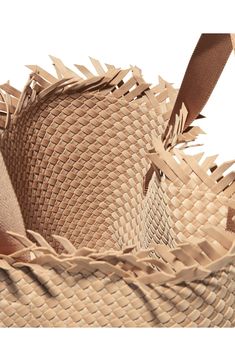 A woven construction and roomy interior lend signature appeal to a boho-inspired tote featuring an unfinished topline. Magnetic tab closure Top carry handles Removable zip pouch Unlined Synthetic Imported Beige Bucket Bag With Intrecciato Weave For Vacation, Natural Woven Leather Hobo Bag For Travel, Beige Bucket Bag With Intrecciato Weave, Beige Leather Handwoven Bucket Bag, Natural Leather Woven Bucket Bag, Handwoven Beige Leather Bucket Bag, Light Brown Tote Bucket Bag With Braided Handles, Light Brown Bucket Bag With Braided Handles, Natural Bucket Bag With Intrecciato Weave