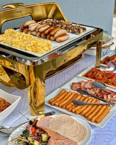 an assortment of food is displayed on a buffet table