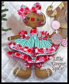 a brown teddy bear wearing a pink and green dress next to a christmas ornament