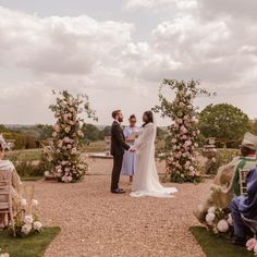 a bride and groom standing at the end of their wedding ceremony