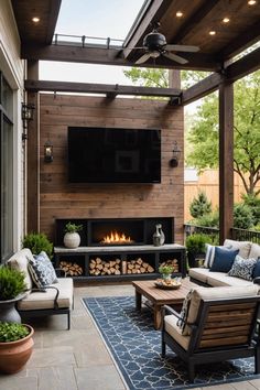 an outdoor living area with couches and fireplace