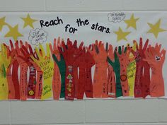 a bulletin board with handprints and writing on it that says reach for the stars