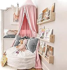 a bedroom with a canopy bed and stuffed animals on the pillow in it's corner