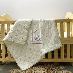 a baby crib with a blanket on top of it