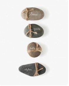 three rocks with names tied to them