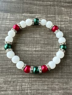 This bracelet is made with green and red pearl beads, rhinestone spacers, white glass beads. Note: Colors may vary depending on your monitor Shipping Info: All orders are shipped from Canada and they are sent through Canada Post.  If you would like expedited shipping it will cost more and reach out and I can give pricing. Within Canada: Sent regular mail with no tracking.  It can take 5-10 business days to arrive. United States: Sent with tracking  International: Sent International Air and on av Christmas Glass Bead Bracelet, Red Pearl Bracelet, Red Bracelet Ideas, Christmas Bracelet Ideas, Winter Bracelets, Christmas Bead Necklace, Winter Bracelet, Make Clay Beads, Holiday Bracelets