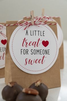 some chocolate candies sitting on top of a table next to a brown paper bag