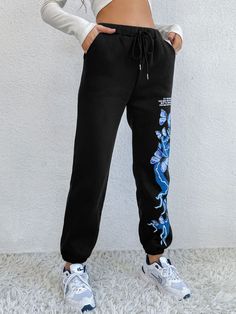 Turn heads on the track or in the gym with these joggers that have a high-waist design, a drawstring closure and stretchy, comfortable fabric. Size Guide: Alina is 5’7” tall, and has a 31.1” bust, 22.8” waist, & 34.6” hips. She is wearing a S / US 4 / AU 8. This pants is true to size. Material: 65% polyester / 35% cotton Feature: Relax fit, Graphic print, Twin hip pockets Care Instructions: Machine wash / Cold hand wash Black Drawstring Sportswear Pants, Stretch Joggers With Drawstring For Streetwear, Stretch Drawstring Joggers For Streetwear, Black Sportswear Sweatpants For Workout, Black Athleisure Joggers For Jogging, Sporty Black Sweatpants For Workout, Spring Athleisure Activewear With Drawstring, Black Drawstring Joggers For Workout, Black Joggers With Drawstring For Workout