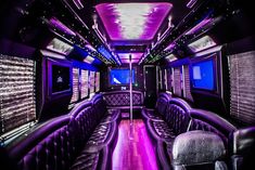 the inside of a bus with purple lights and leather seats on it's sides