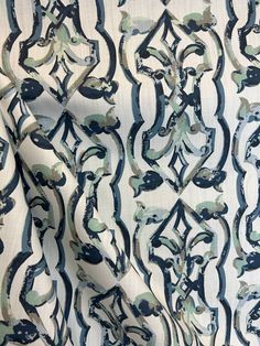 the fabric is blue and white with black swirls