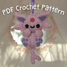 a crocheted pink and purple cat ornament hanging from a string with text overlay that reads, pdf crochet pattern