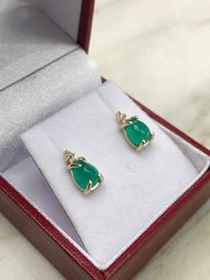 Featured here is a beautiful set of cabochon cut Colombian emerald & diamond studs in fine 14K yellow gold. Displayed are medium-green emeralds with very good transparency, accented by brilliant round diamonds in a simple four-prong gold mount, allowing for the emerald to be shown in full view. The earth mined, green Colombian emeralds have a desirable lush green color with excellent qualities. These earrings are ideal for everyday use and are the perfect accessory to any outfit. Emerald cab Emerald Cabochon Earrings As A Gift, Emerald Cabochon Earrings For Gift, Teardrop Cabochon Earrings For Anniversary, Earrings Emerald, Emerald Earrings Studs, Colombian Emeralds, May Birthstone, Diamond Stud Earrings, Emerald Earrings