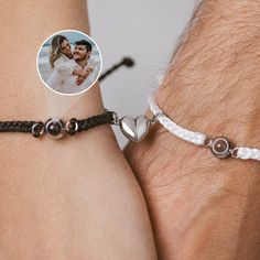 two people wearing bracelets that have hearts on them and one is holding the other