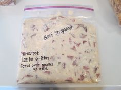 a bag of beef stroganoff sitting on top of a table next to some bread