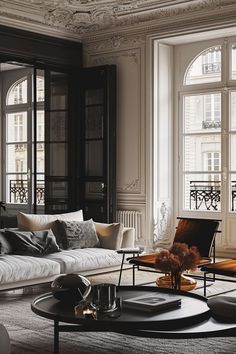 a living room filled with furniture and windows