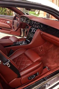 the interior of a car with red leather