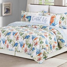 the comforter is made up with blue and orange flowers on it, while the bedding