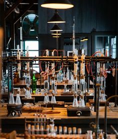 the lab is filled with many different types of beaks and flasks in glass bottles