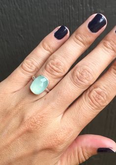 A stunning light aqua blue chalcedony has been set in sterling silver with a handmade ring band from sterling silver half dome wire. The cushion cut rectangle stone is 14mm x 10mm in size. The faceted cut of the stone gives the ring a geometric look that also helps catch the light and sparkle. This stone is a light blue as pictured but certain light can bring out a green hue to the stone. Made to order!Chalcedony is the horoscope stone for cancers, June and July birthdays. Modern Silver Chalcedony Jewelry, Modern Chalcedony Rings For Gift, Turquoise Chalcedony Gemstone Rings, Turquoise Chalcedony Ring Jewelry, Boho Rocker, Rectangle Cushion, Chalcedony Ring, And July, Light Aqua