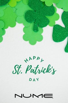 some green shamrocks are next to a white card that says happy st patrick's day