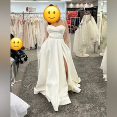 a woman in a white wedding dress with an emoticive smile on her face