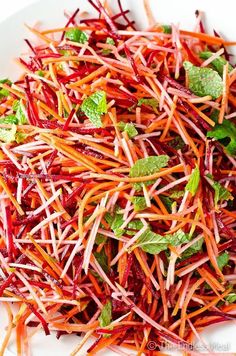 shredded carrots and radishes on a white plate