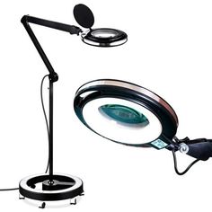 a magnifying glass sitting on top of a table next to a black lamp