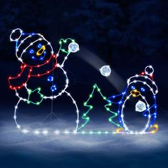 two snowmen with christmas lights on their heads