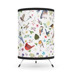 a white lamp with birds and flowers on it