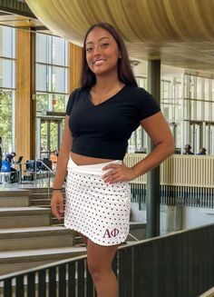 Fully licensed Alpha Phi skirt has shorts with side pockets - perfect for work week and during i-week as a gift for your Little. Celebrate your sisterhood with flair even beyond your college years. Soft, comfortable material and shorts with pockets! White with maroon polka dots, V-shaped waistline, and thoughtful detailing, "Make a Difference", on the back. Custom orders available. We could even design a look specific to your chapter. A Portion of every purchase directly supports Alpha Phi. Manufactured in America and shipped straight to you. Designed by Women for Women. If you are interested in customizing this skirt please email us. Once we get approval from Alpha Phi, we are happy to make your special skort. All skirts are made to order. Please allow 2-3 weeks for delivery.  * Ladies si Athleisure Short Skort For Cheerleading, Casual Summer Cheerleading Skort, Casual Cotton Tennis Skirt For Cheerleading, Casual Short Tennis Skirt For Cheerleading, White Casual Skort For Cheerleading, Casual White Skort For Cheerleading, Casual Cotton Skort For Cheerleading, Alpha Phi Sorority, Womens Skorts