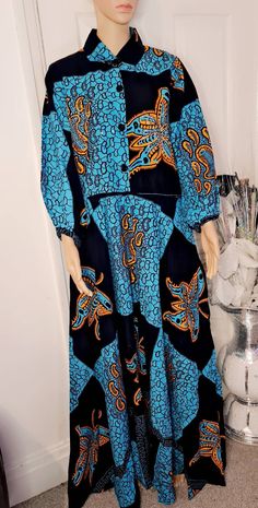 This is a beautiful African print dress with Rhinestones details ,specially made with quality material. It is 100% cotton. Patterned Cotton Dress With Graphic Print, Cotton Graphic Print Patterned Dresses, Casual Cotton Dresses With Matching Set, Patterned Maxi Dress With Batik Print, Bohemian Long Sleeve Dress With Graphic Print, Long Sleeve Bohemian Dress With Graphic Print, Blue Cotton Dress With Graphic Print, Fitted Cotton Dresses With Matching Set, Patterned Long Sleeve Dress With Graphic Print