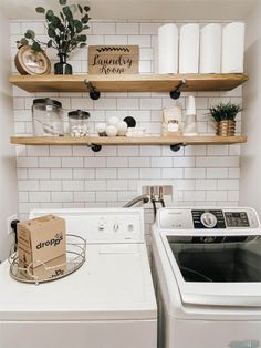 a white washer and dryer sitting next to each other in a laundry room