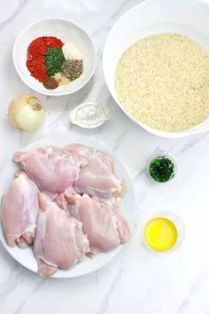 the ingredients to make this dish include chicken, garlic and seasonings on a white marble countertop